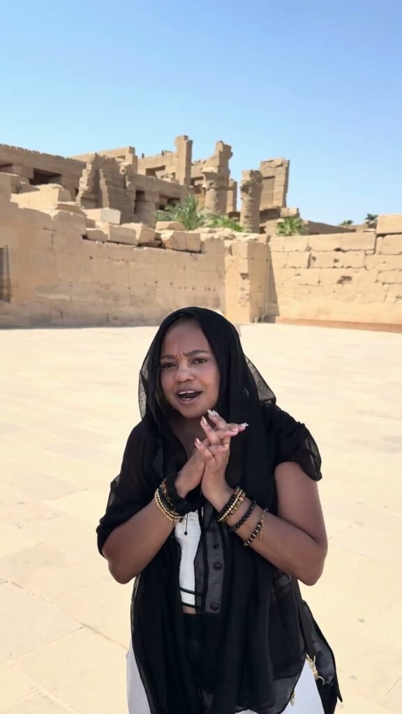 Sasha from Jamaica speaking at Karnak Temple, Luxor, about her Dr Mo Tours experience